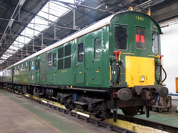 [PHOTO: green train in depot shed: 52kB]