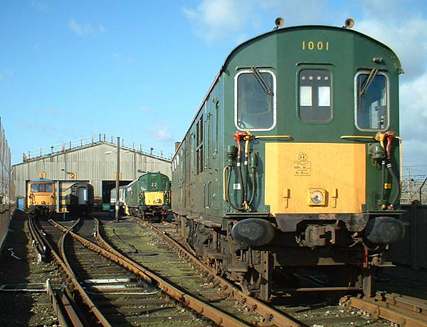 [PHOTO: motor coach in foreground, depot yard in background: 67kB]