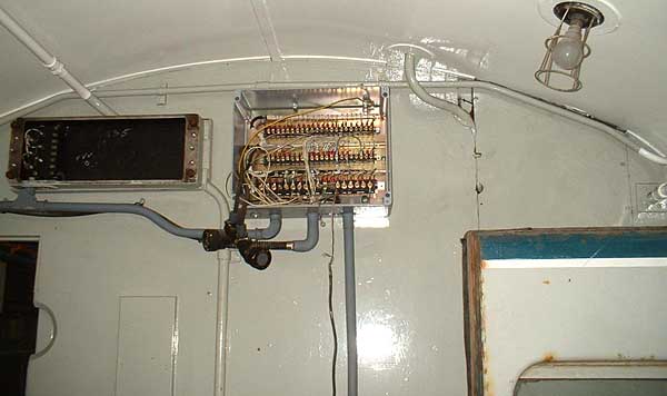 [PHOTO: interior of guard’s van with new wiring-connection box: 26kB]
