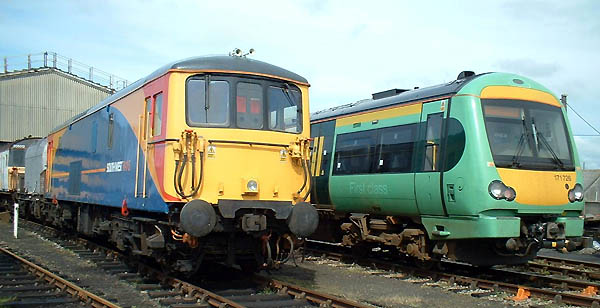 [PHOTO: BR-blue loco and green DMU in depot yard: 45kB]