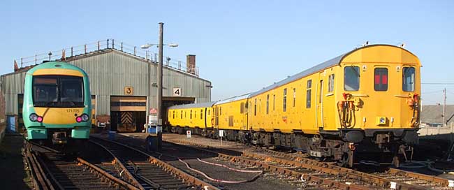 [PHOTO: Two trains in sunny depot yard: 30kB]