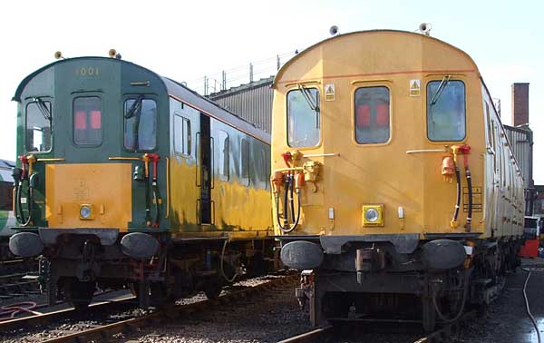 [PHOTO: Two trains in sunny depot yard: 35kB]