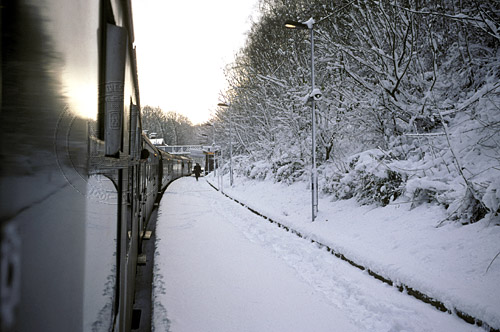 [PHOTO: Train at snowy station from on-board: 60kB]