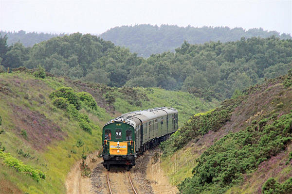 [PHOTO: Train in lush countryside: 54kB]