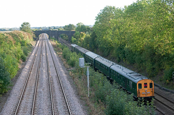[PHOTO: Train receding in evening countryside: 69kB]