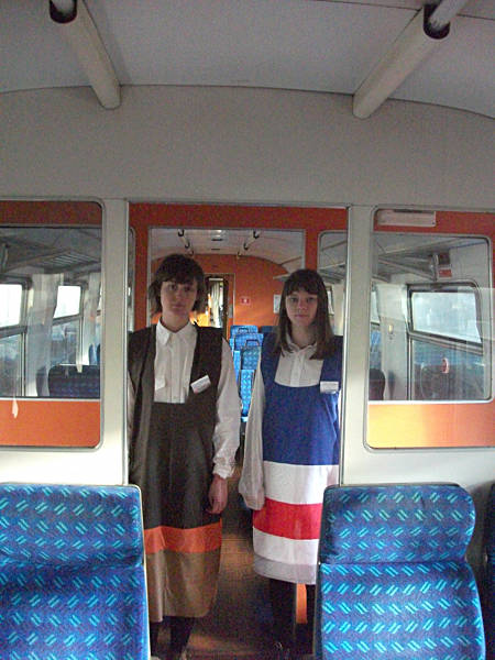 [PHOTO: Two railway-livery dresses modelled: 56kB]