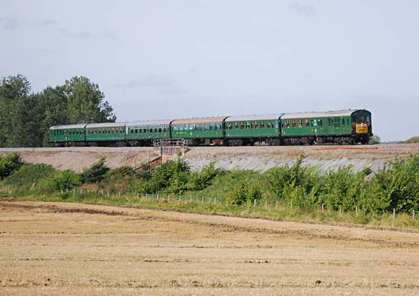 [PHOTO: Train passing through countryside: 45kB]