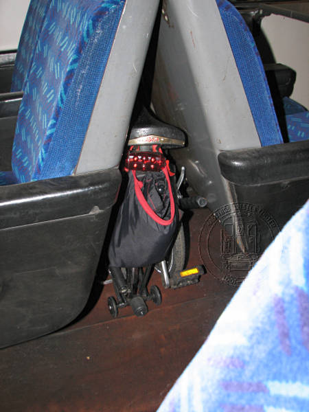 [PHOTO: Brompton between seat-backs in CEP coach: 43kB]